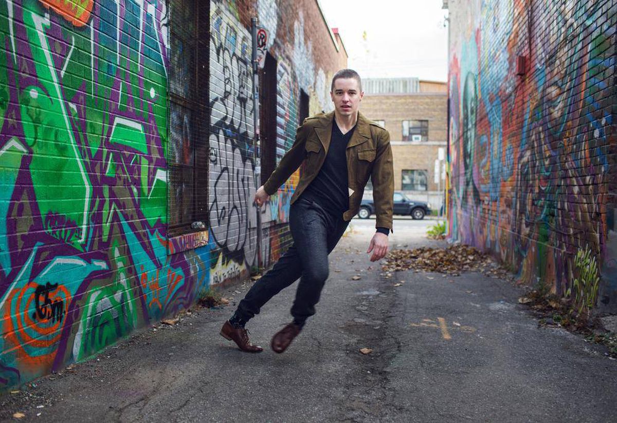 Jacob Niedzwiecki dances in a grafitti alley.